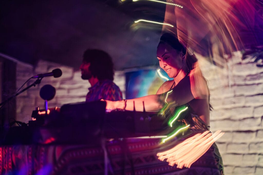 DJ performing with light trails at a night party in Surfers Paradise