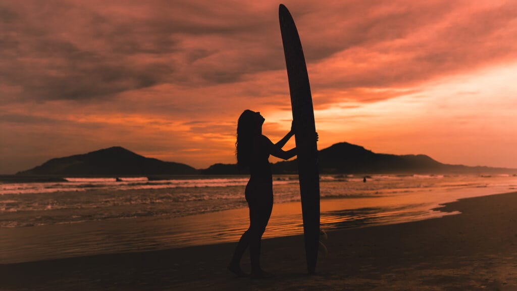 Silhouette with a surfboard on the beach at sunset, Gold Coast
