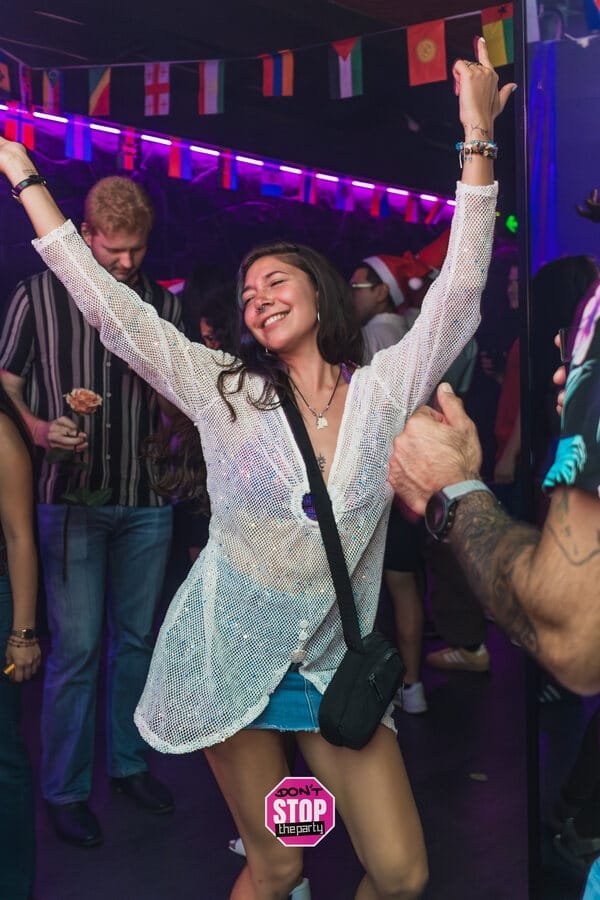 A guest celebrating on the dance floor at a recurring party, event photographer in Gold Coast