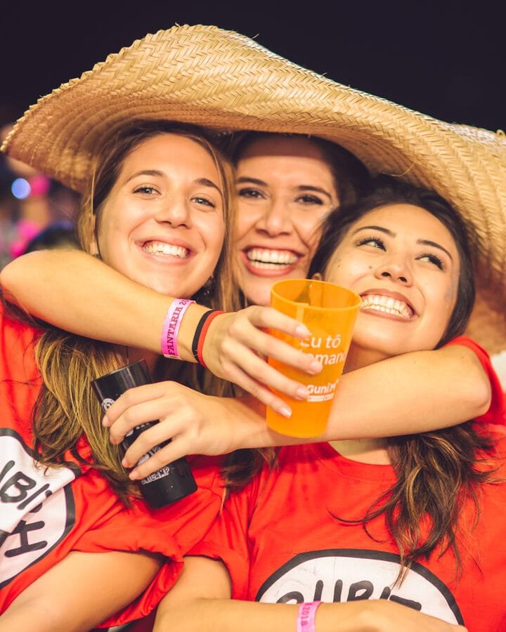 Friends hugging and smiling at an event, event photographer in Gold Coast