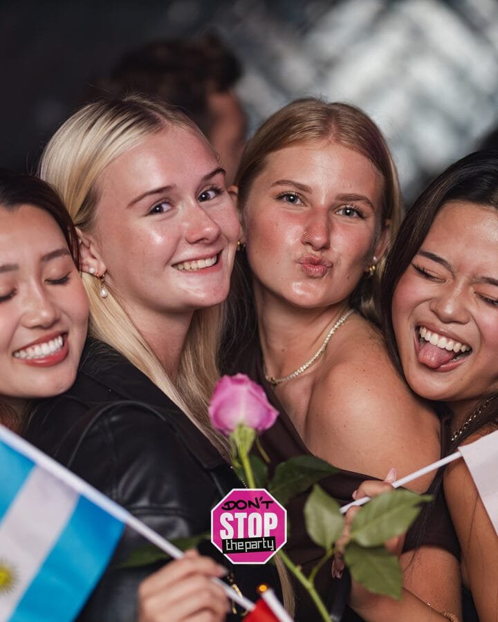 Friends celebrating with flags at an event in Gold Coast