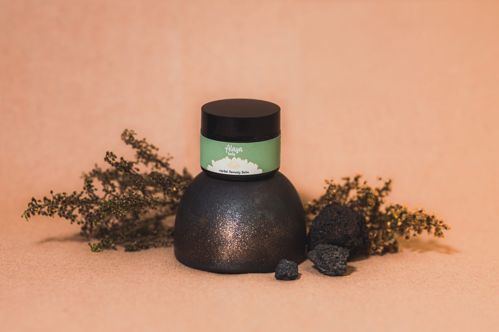 Alaya Body jar on a dark textured stand with dried native branches