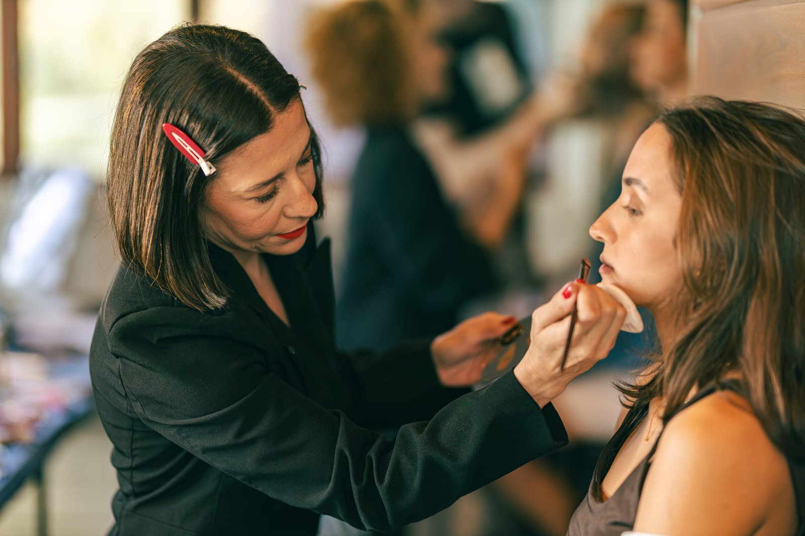 Makeup artist finishing a model before the show