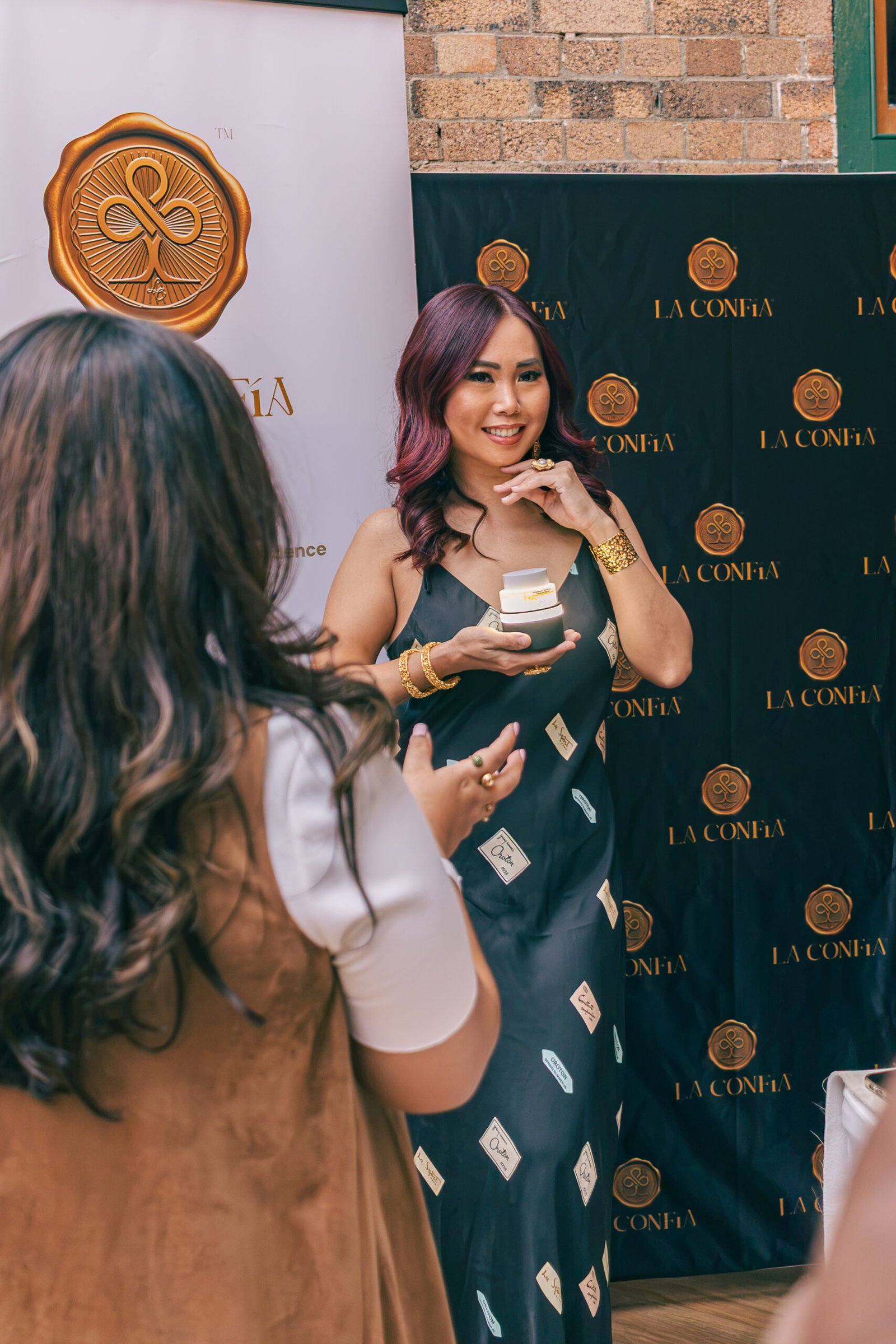 Brand founder showing a product at her stand, Brazil Week Fashion Day
