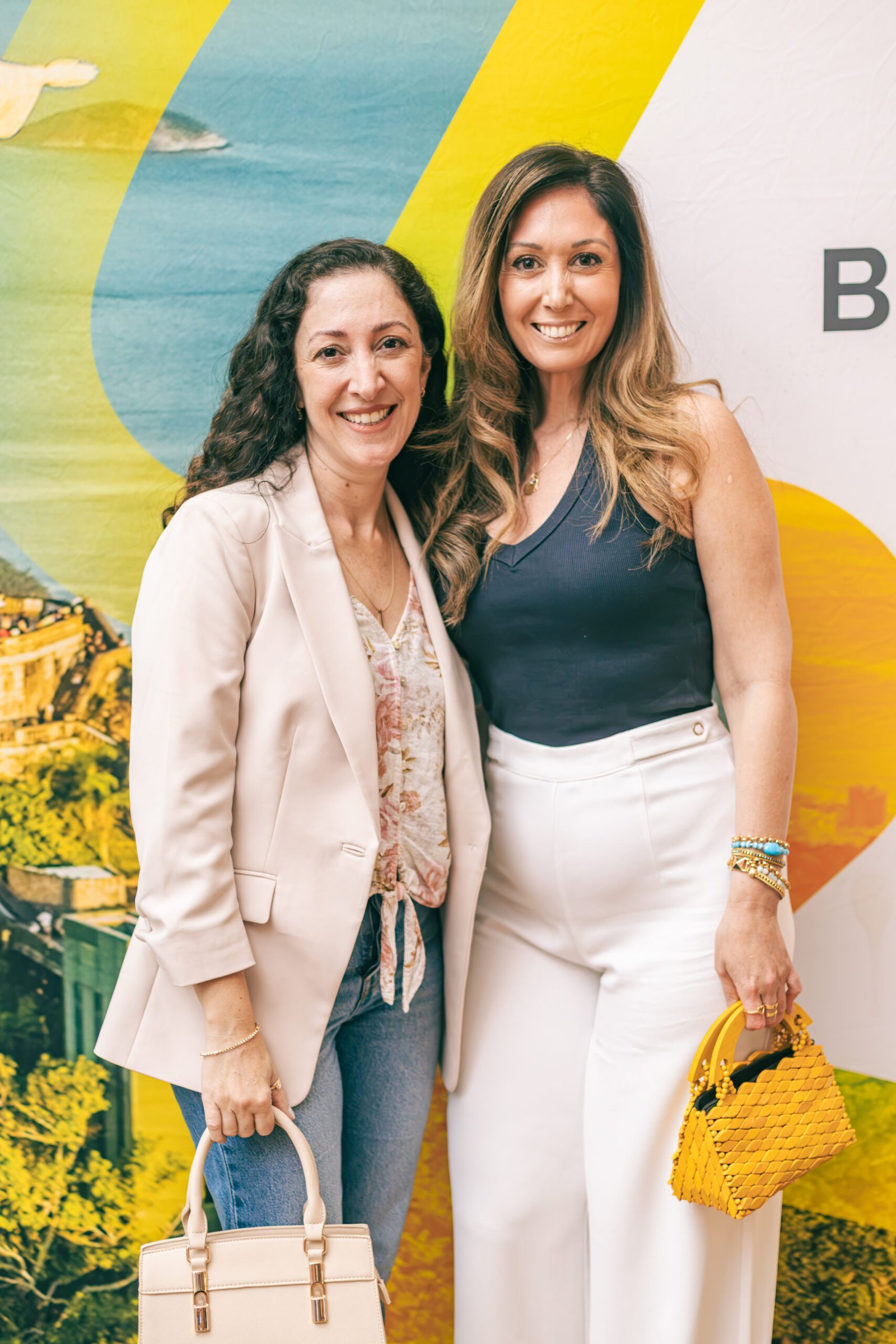 Two guests in front of the Brazil Week backdrop