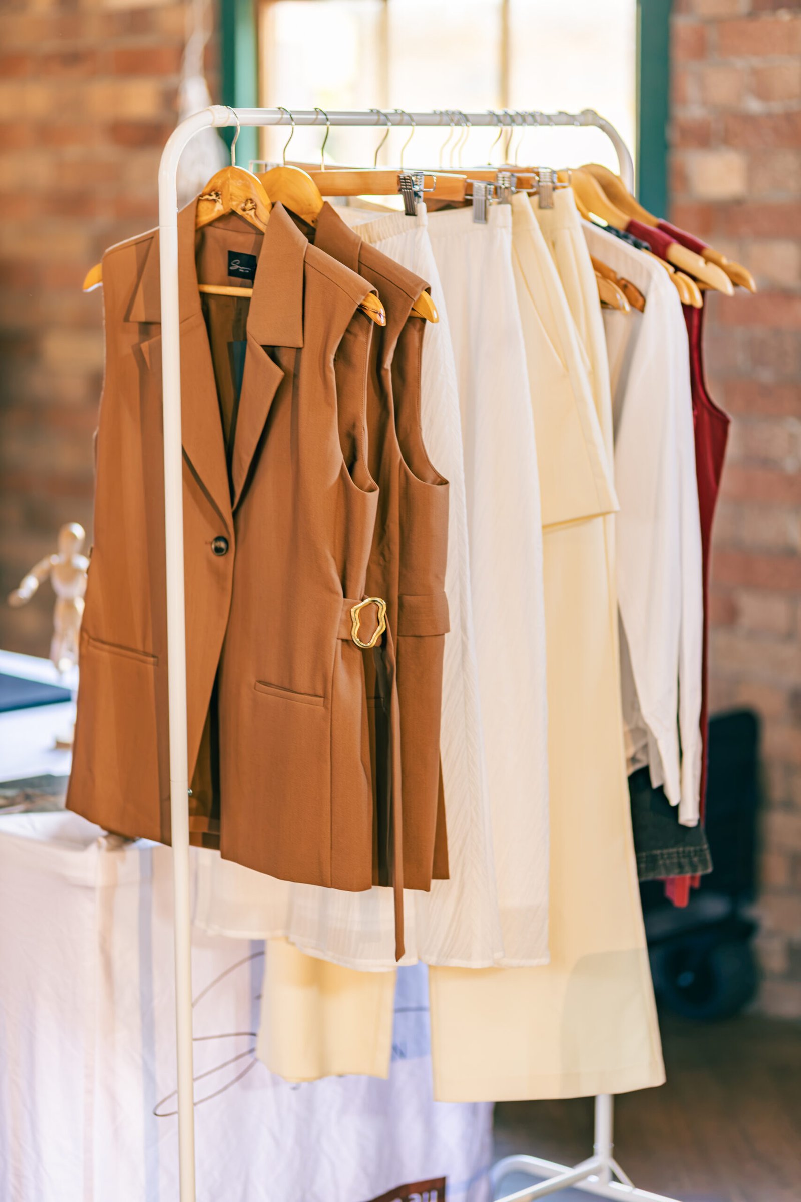 Rack of neutral tone pieces before the show at Brazil Week Fashion Day
